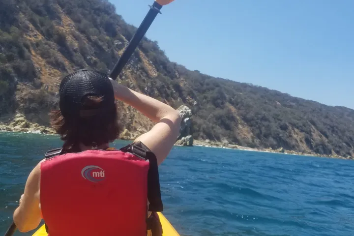 a man standing next to a body of water