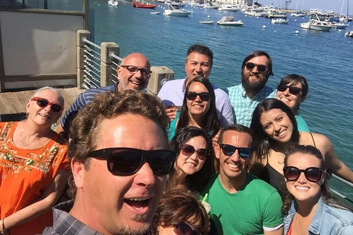 Marzio Bruseghin et al. posing in front of a body of water