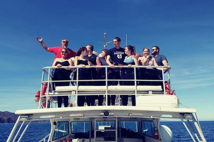 a group of people riding on the back of a boat