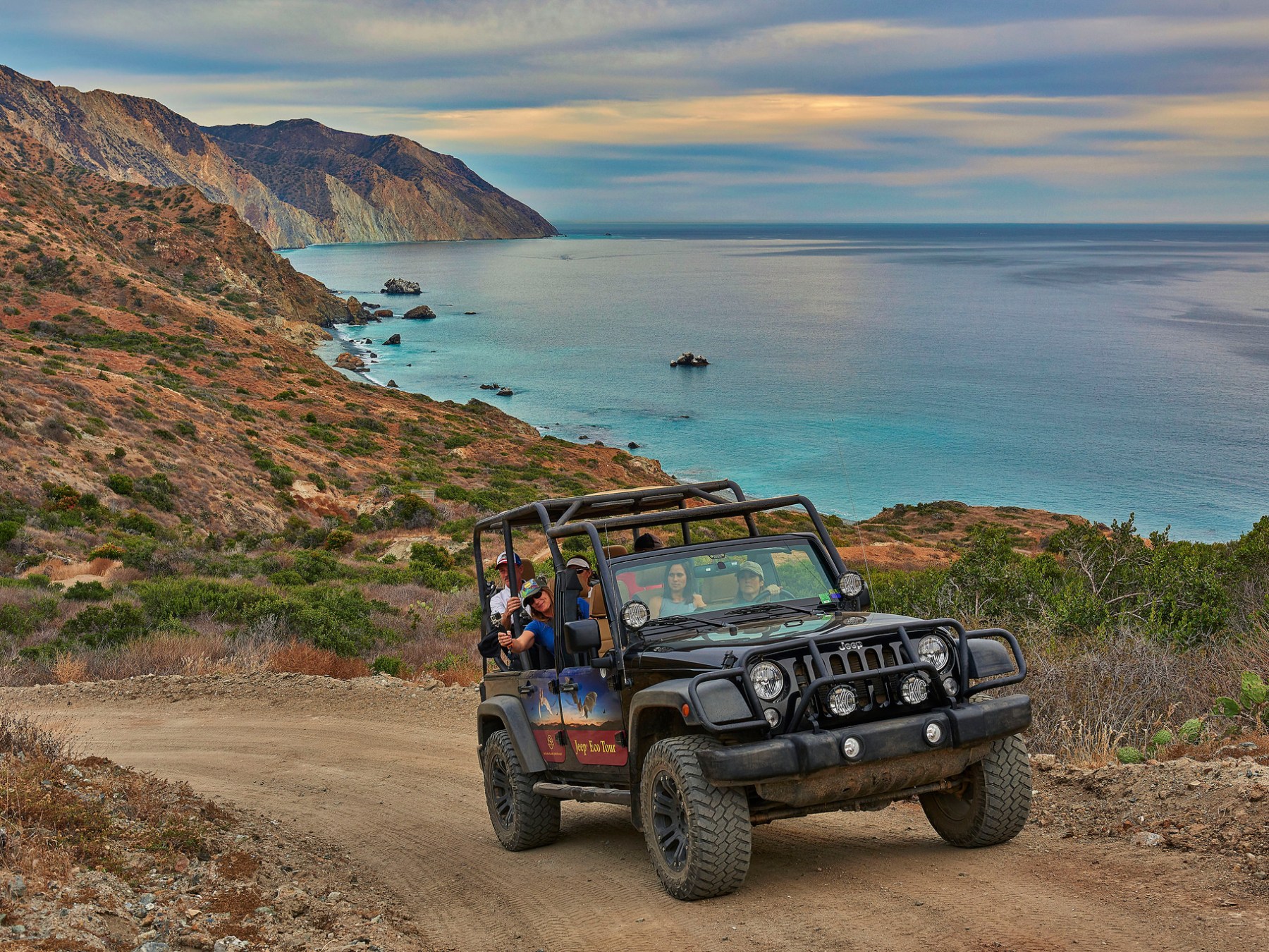 a truck is parked on the side of a mountain