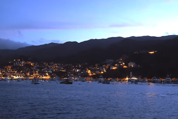a large body of water with a city in the background