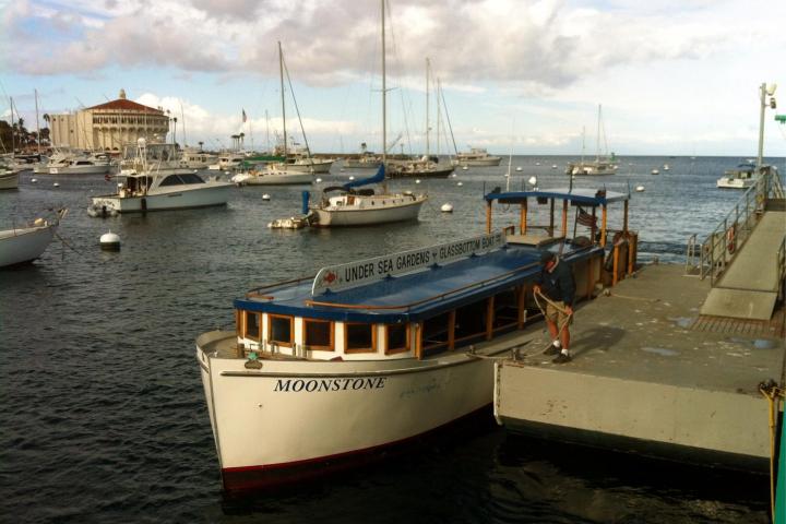a boat is docked next to a body of water