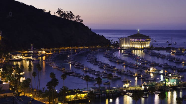 a large body of water with a city in the night sky