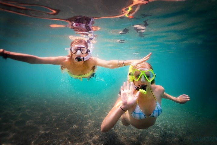 a woman swimming in a pool of water