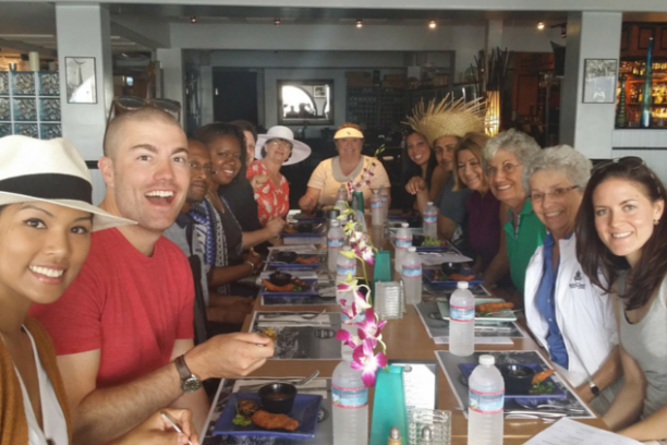 a group of people sitting at a table in a restaurant