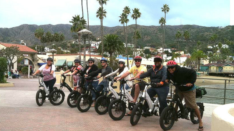 a group of people riding on the back of a motorcycle