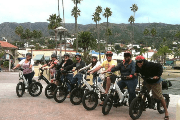 a group of people riding on the back of a motorcycle