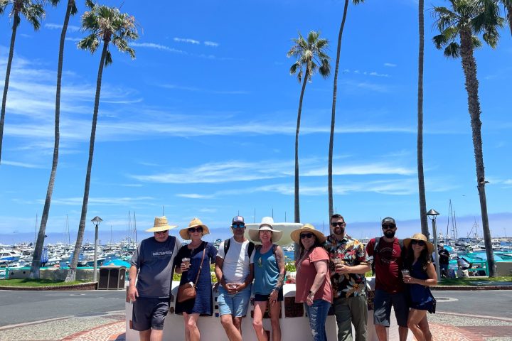 a group of people posing in front of the sombrero fountain on Catalina Island