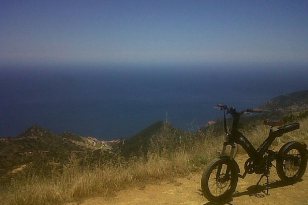 a motorcycle parked on the side of a mountain