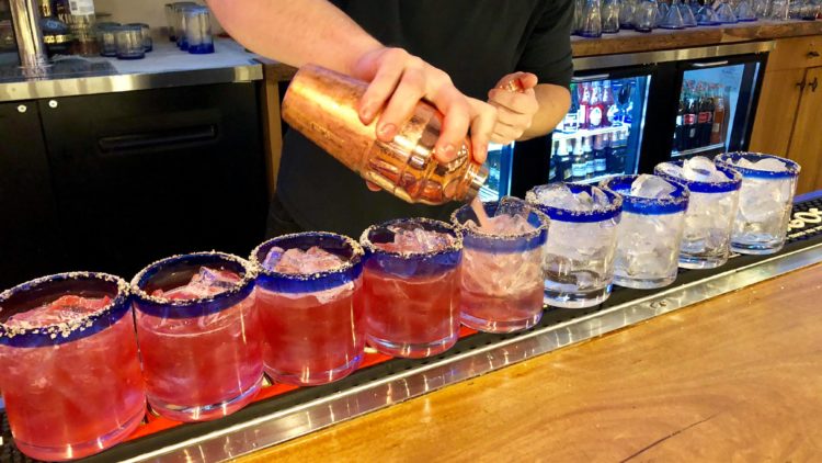 Holiday-Cocktails-on-Santas-Happy-Hour-Tour-750×422 a person preparing food in a kitchen