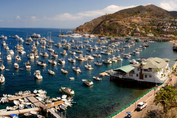 a small boat in a harbor next to a body of water