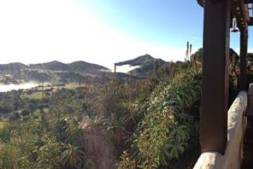 a large building with a mountain in the background