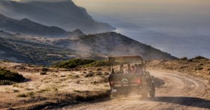 a truck driving down a dirt road