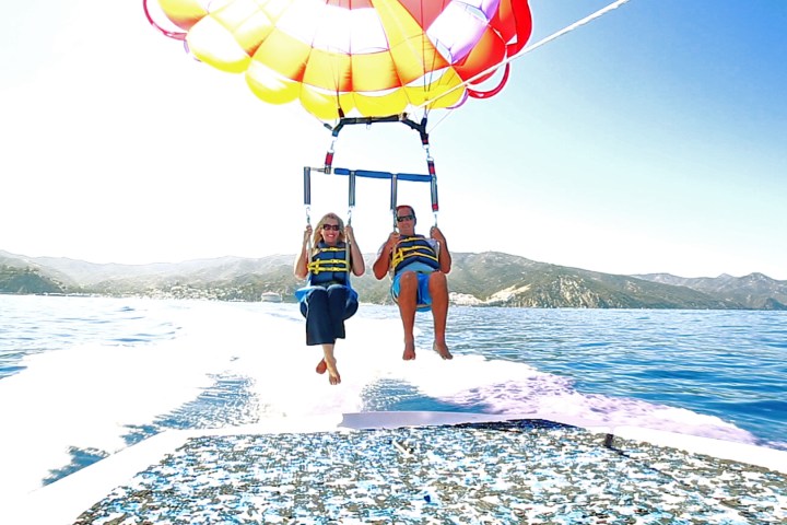 a man standing next to a body of water