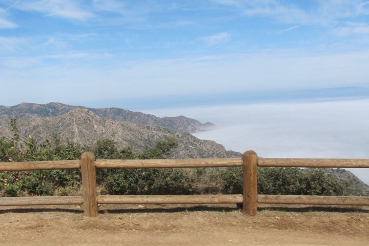 a wooden bench sitting next to a body of water