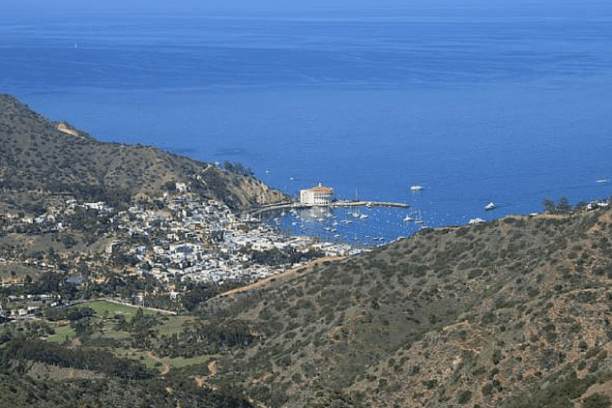 a large body of water with a mountain in the background