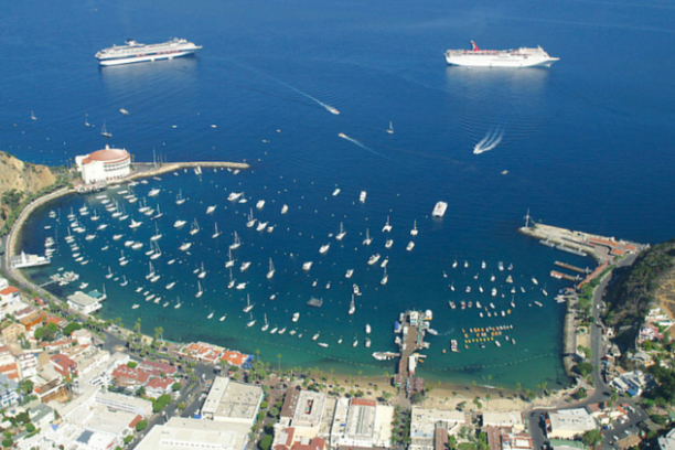 a small boat in a body of water with a city in the background