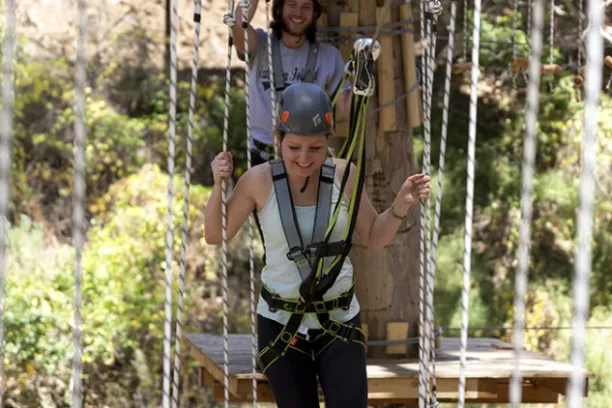 a person standing on a swing