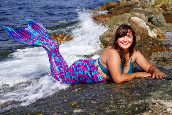 a person standing next to a body of water