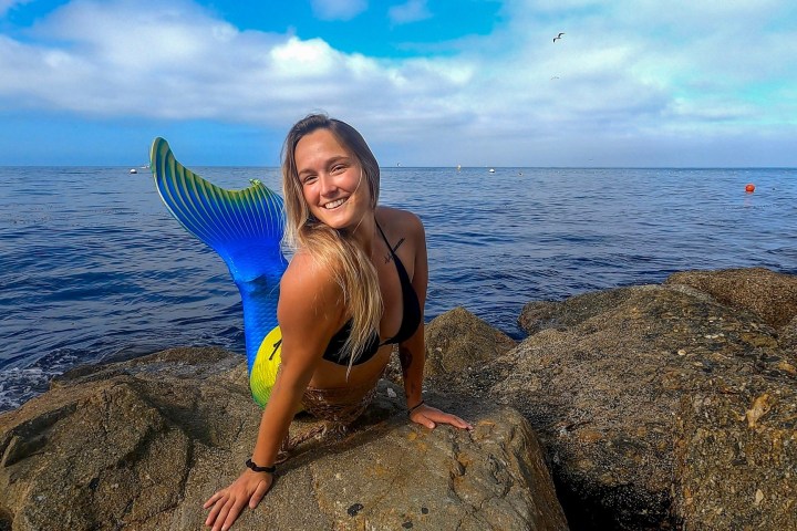 a person standing next to a body of water