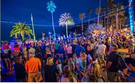 a group of people on a stage in front of a crowd