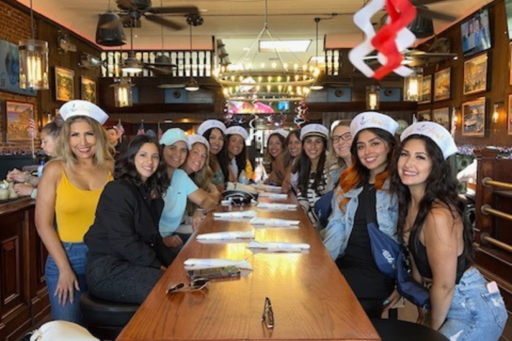 a group of people with sailor hats at El Galleon Restaurant on Catalina Island, CA for a food tour