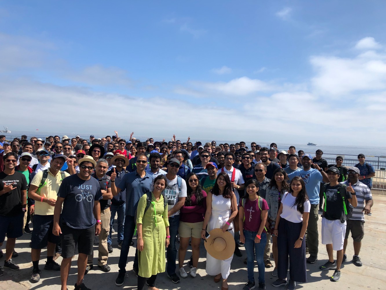 Large corporate team building group of people standing outdoors on a sunny day near the water after the boat ride to Catalina Island.